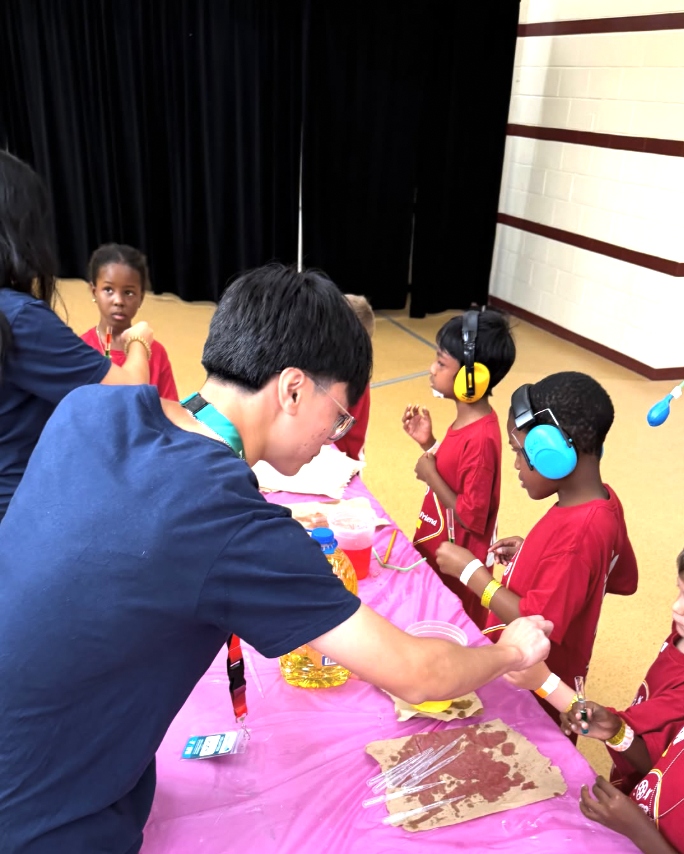 Volunteer helping kids at YMCA event